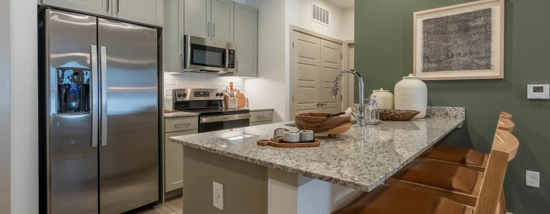 a kitchen with a counter and chairs