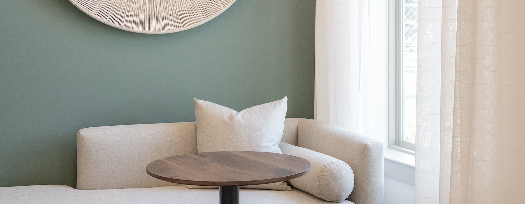 a clubhouse room with a couch and a mirror