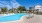a swimming pool with chairs around it