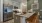 a kitchen with a counter and chairs